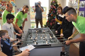 Sergio Aguero, Pablo Zabaleta and Jill Scott playing table football at the Royal Manchester Children's Hospital