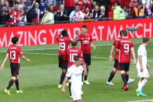 Michael Carrick celebrates a goal in his own testimonial with Louis Saha