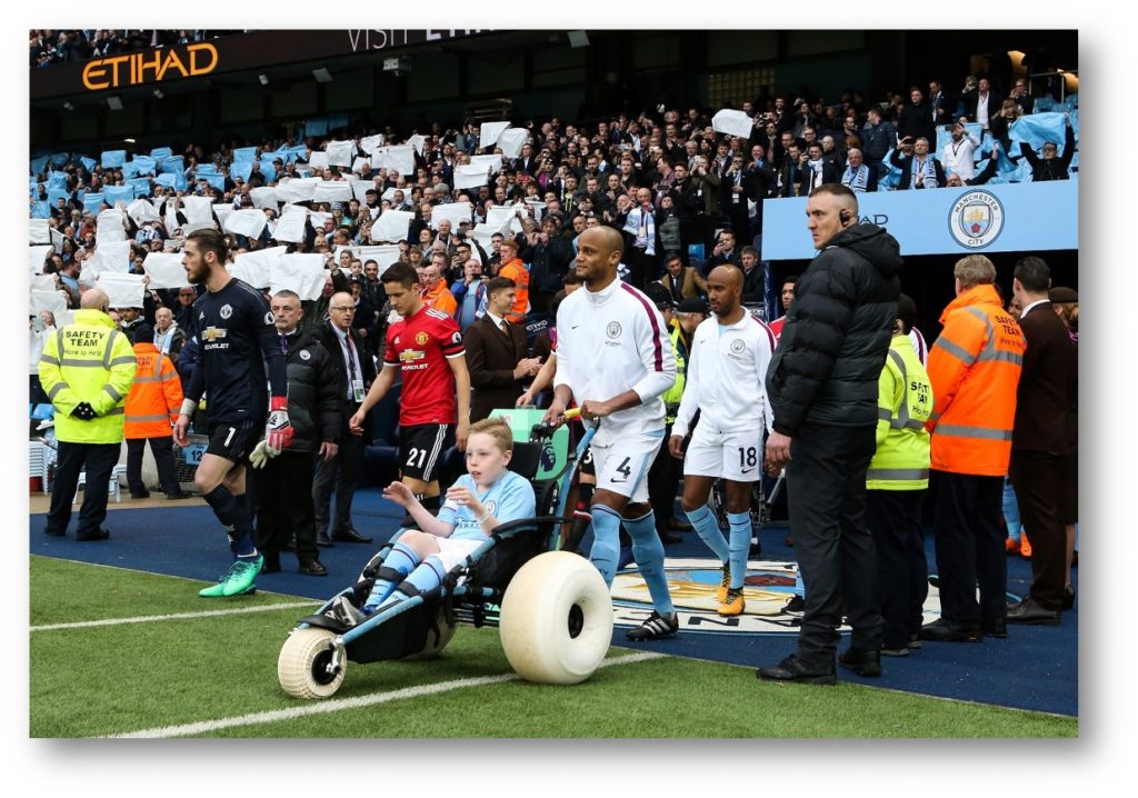 Charlie Kay leads Manchester City out as mascot ahead of the Manchester derby